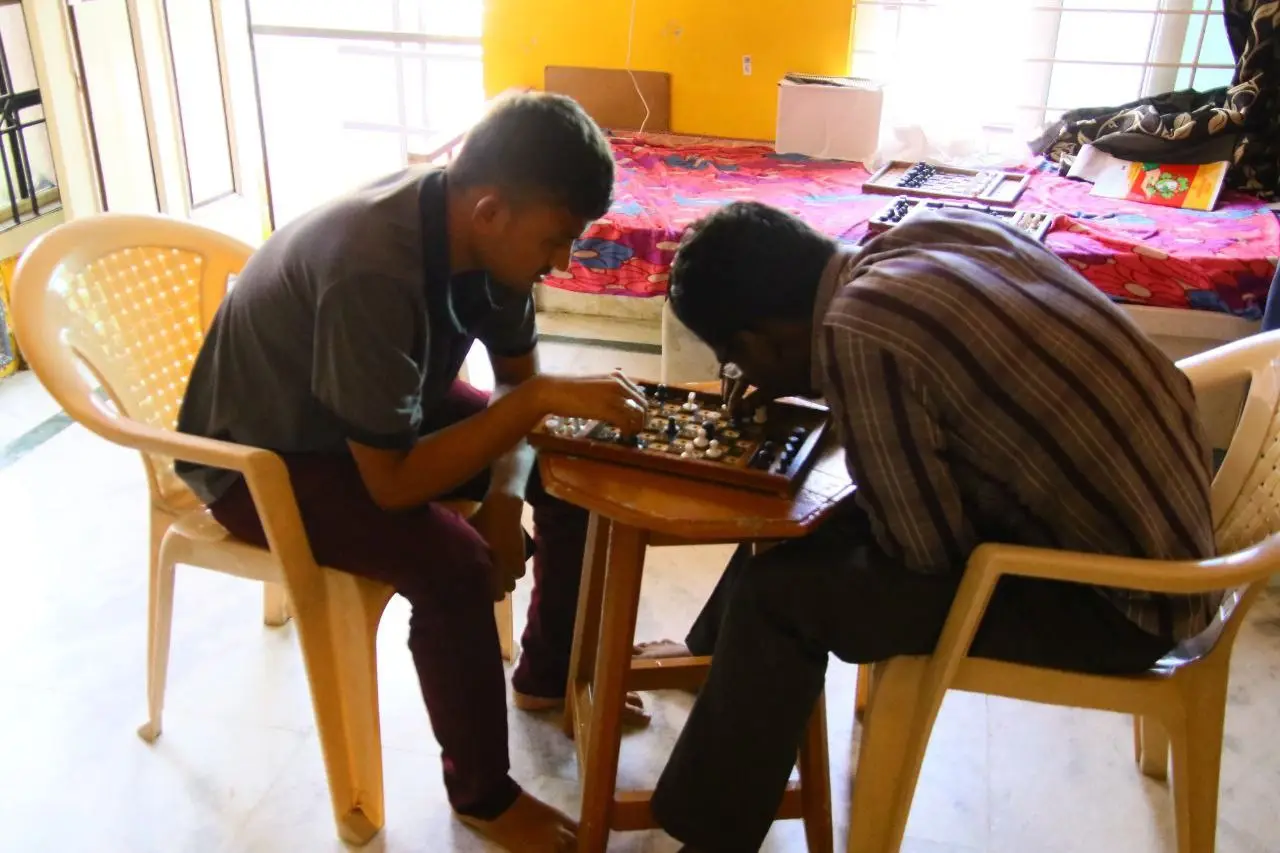 Two residents playing a board game in the afternoon